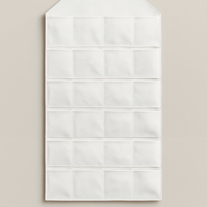 White advent calendar wall hanging with multiple pockets for countdown to holidays