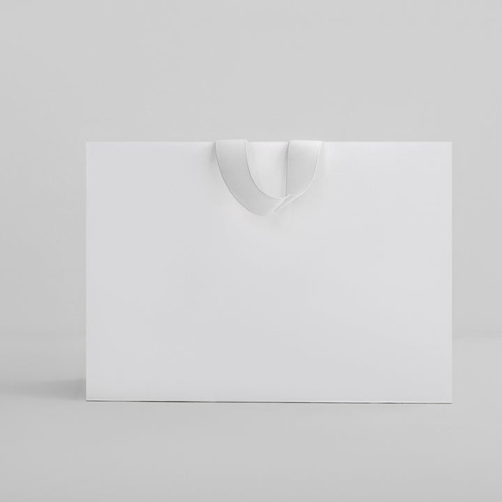 White customizable retail bag with wide handles for easy carrying by dreamwithreem