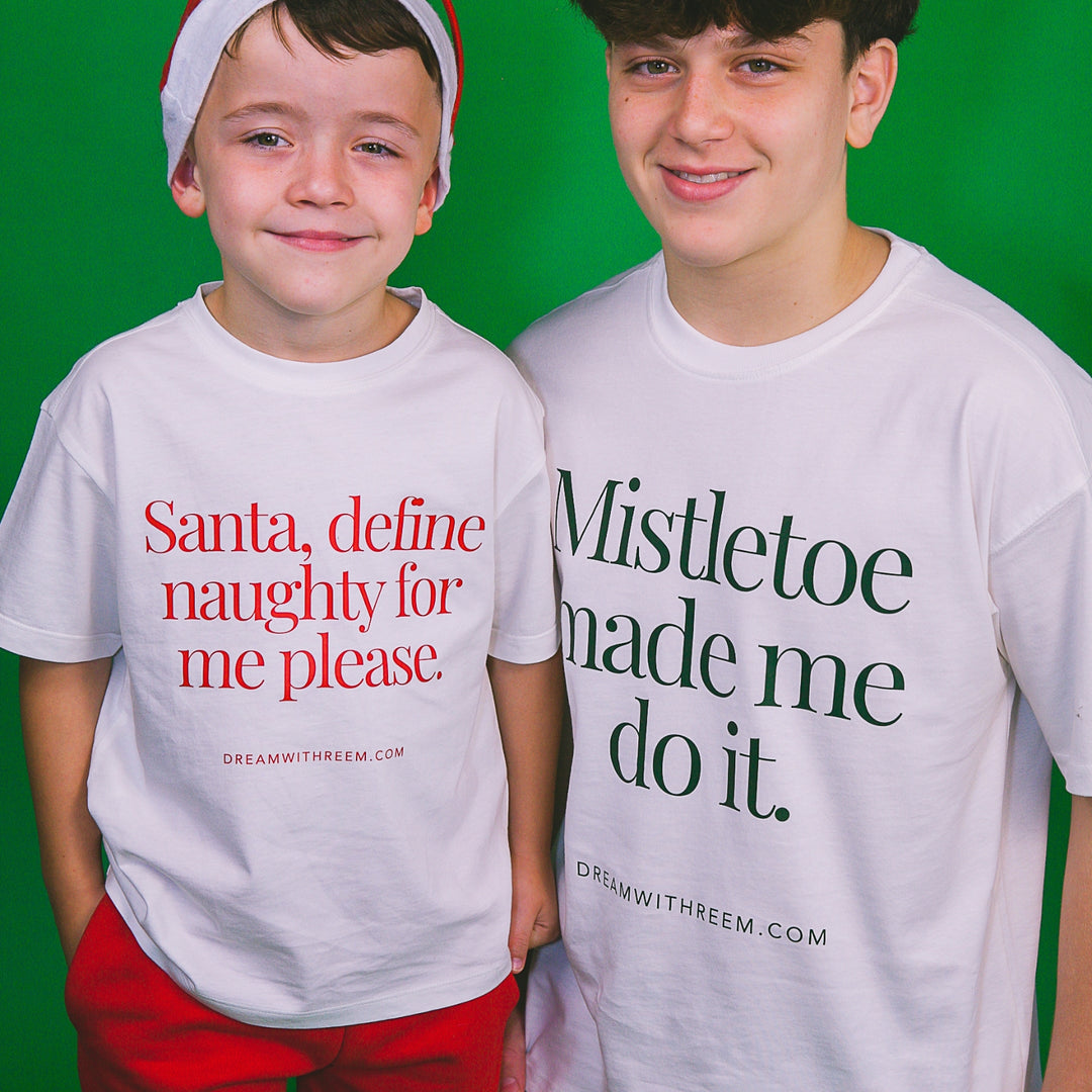 Two kids wearing holiday party graphic tees with fun slogans for festive celebrations