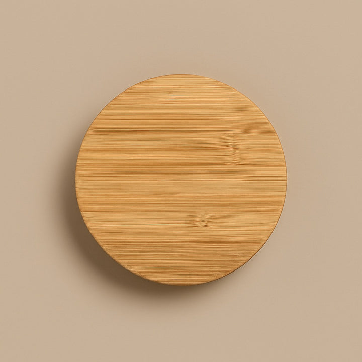Round bamboo coaster with natural wood texture for customizable glass coffee cup