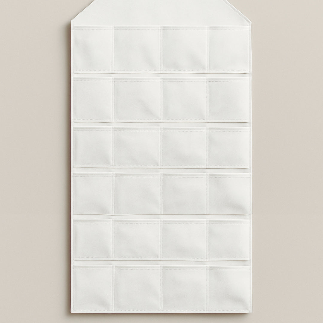 White advent calendar wall hanging with multiple pockets for countdown to holidays