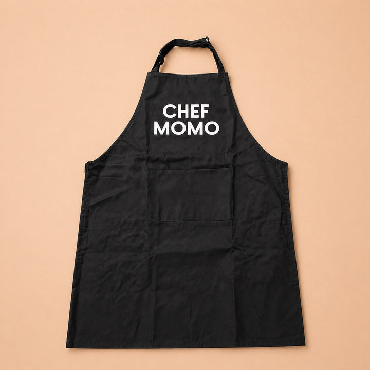 Personalized black custom apron for cooking with the name Chef Momo printed in white