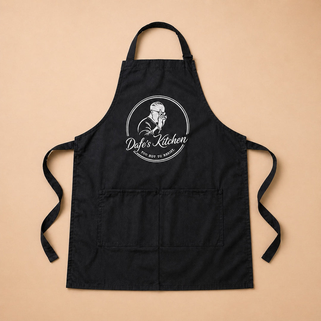 Custom apron featuring Dyef's Kitchen logo with adjustable straps and front pockets