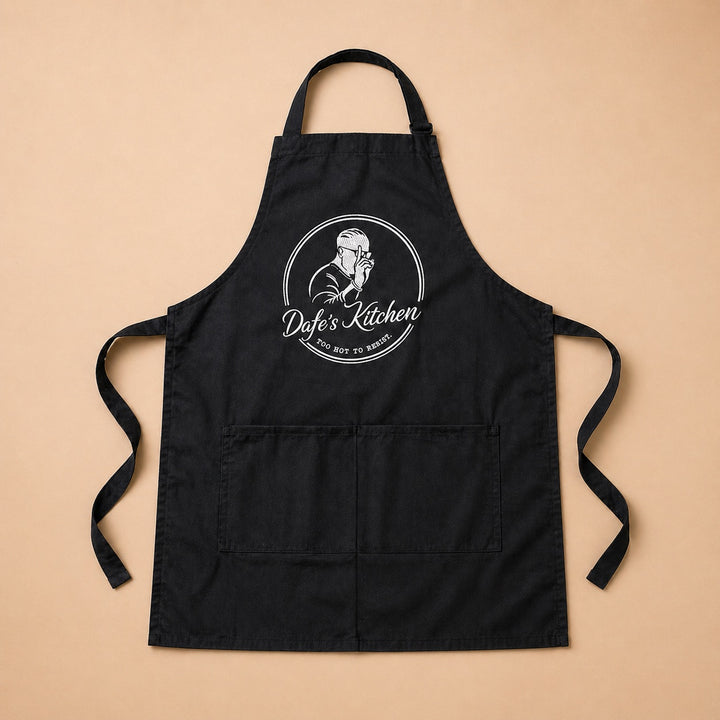 Custom apron featuring Dyef's Kitchen logo with adjustable straps and front pockets