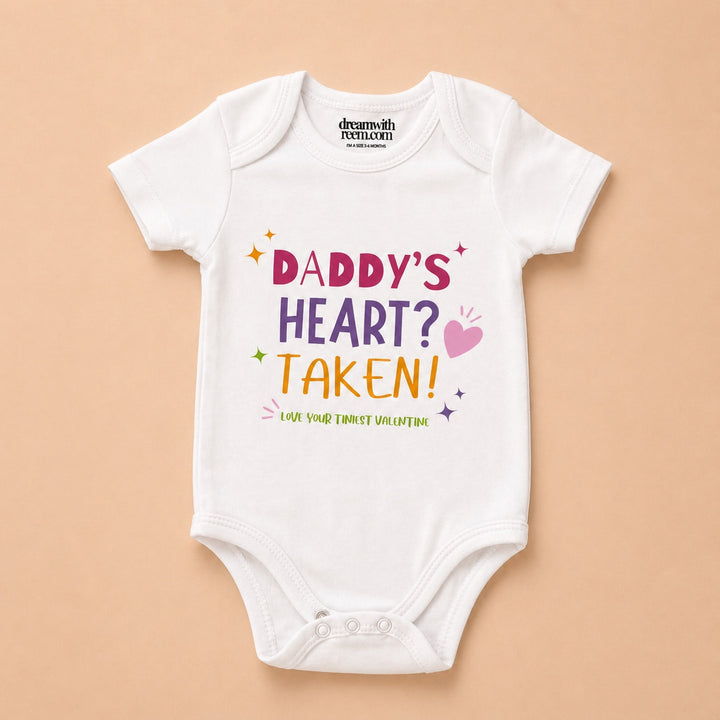 Custom baby onesie with colorful text saying Daddy's Heart? Taken! for special occasions