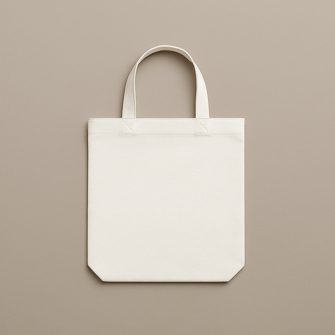 Plain white custom canvas tote bag with sturdy handles on a neutral background