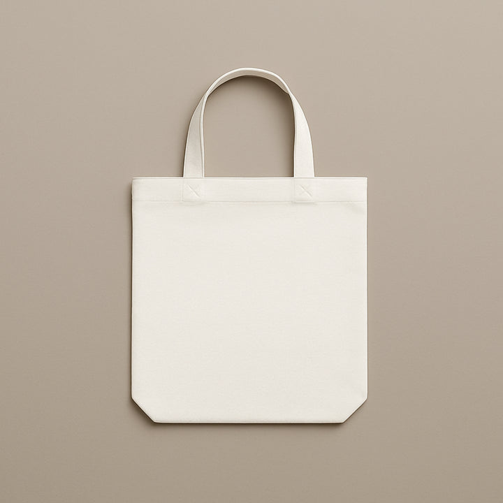 Plain white custom canvas tote bag with sturdy handles on a neutral background