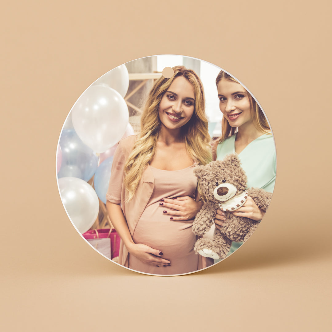 Custom ceramic ornament featuring a photo of two women celebrating a baby shower with a teddy bear
