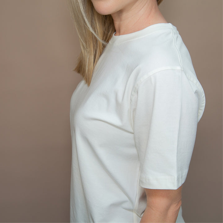Side view of a woman wearing a custom classic fit t-shirt in soft cotton fabric
