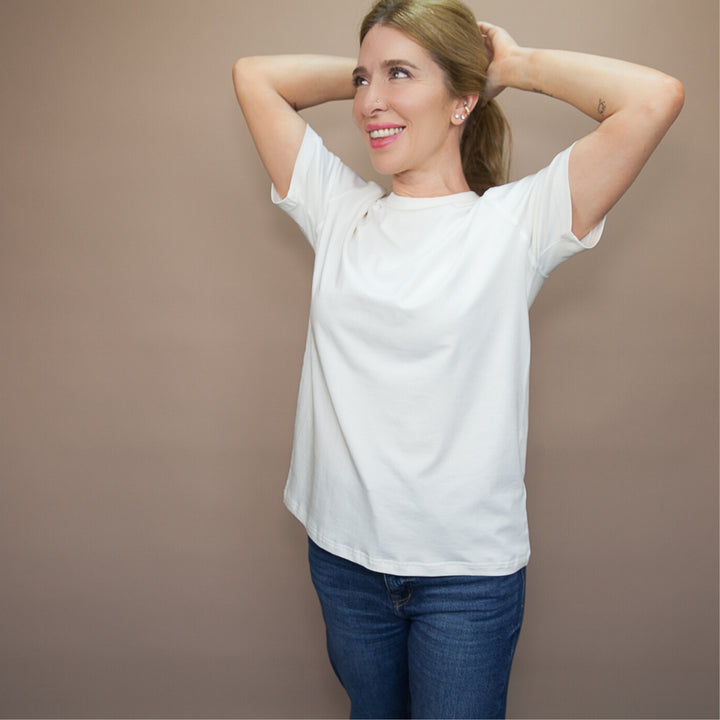 Model wearing a custom classic fit t-shirt in white, styled with jeans for a casual look