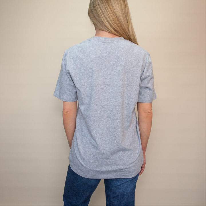 Back view of a woman wearing a gray custom classic fit t-shirt for casual comfort