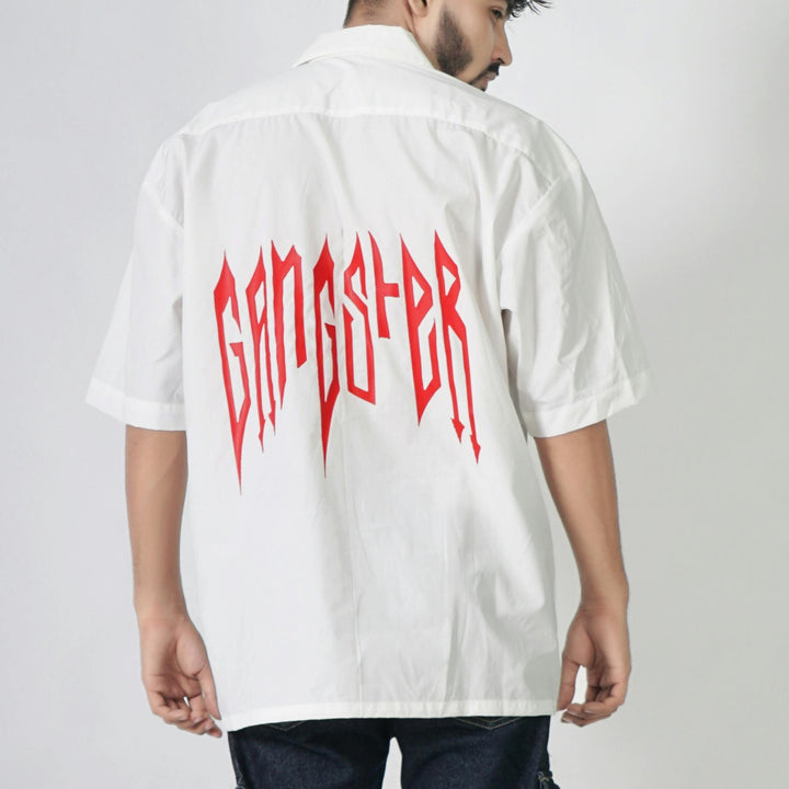 Back view of a white shirt featuring bold red lettering 'GANGSTER' showcasing custom DTF print service