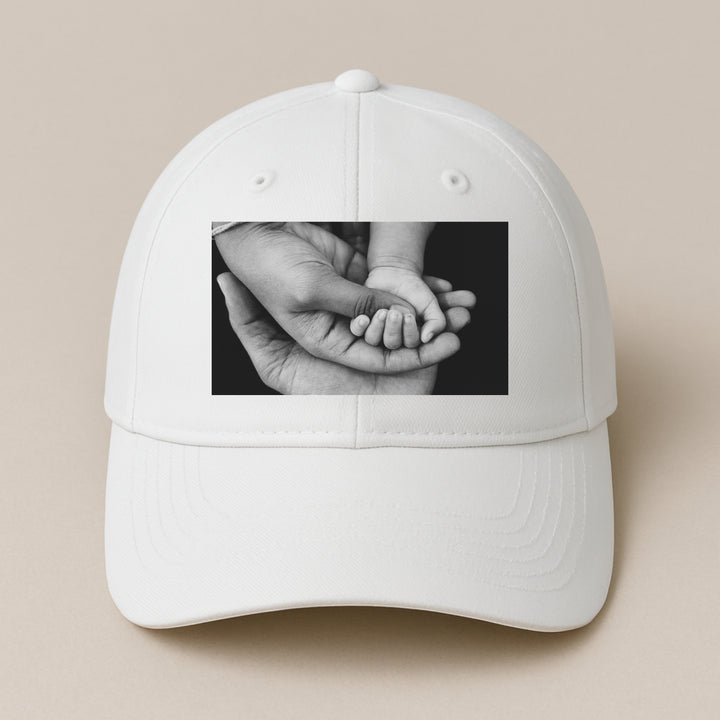 White adjustable baseball cap with black and white photo of adult holding baby hand design your own hat online