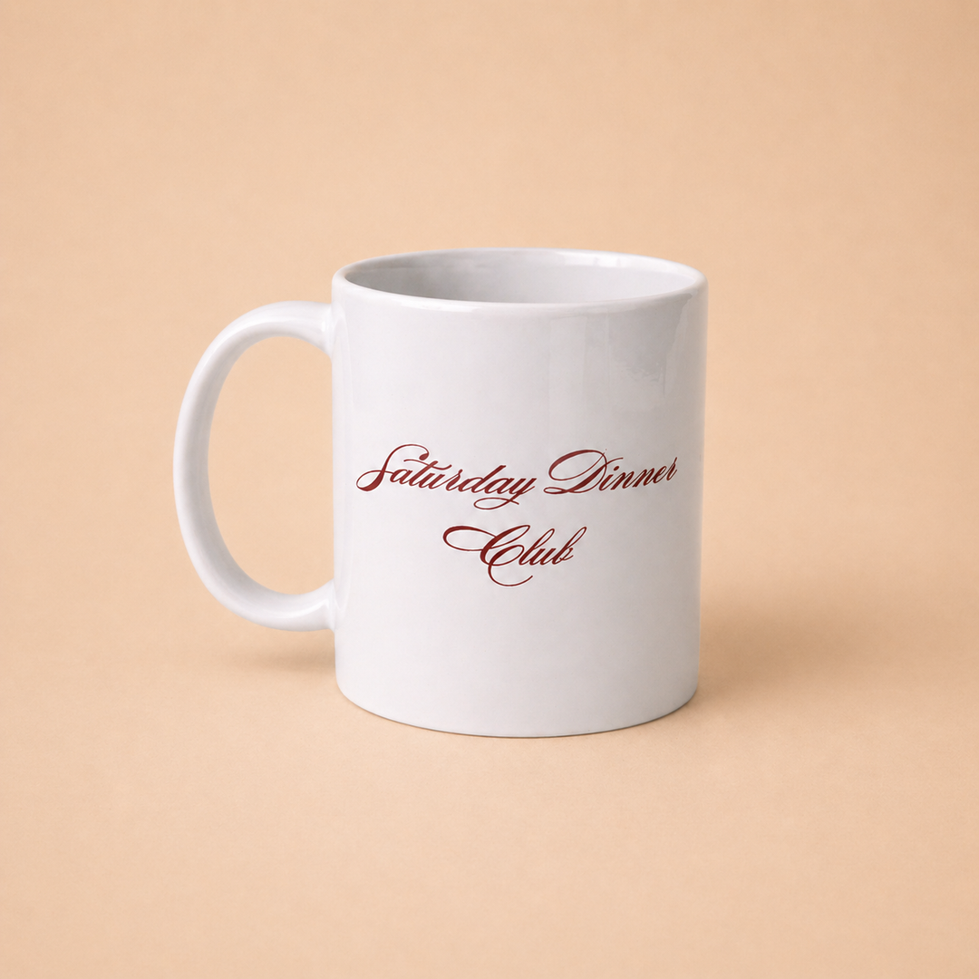Custom mugs featuring Saturday Dinner Club design in elegant script on a white background