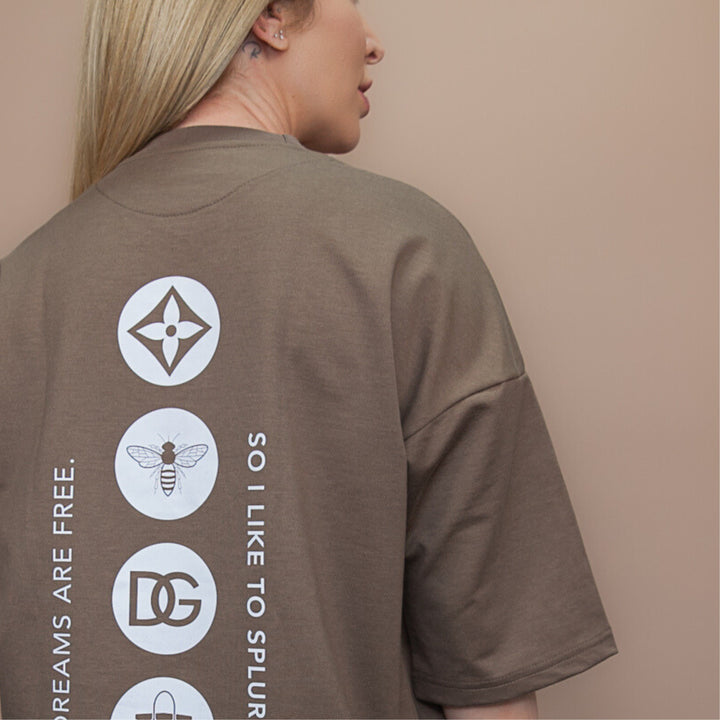 Back view of a custom oversized tee in taupe with unique graphic designs and a relaxed fit