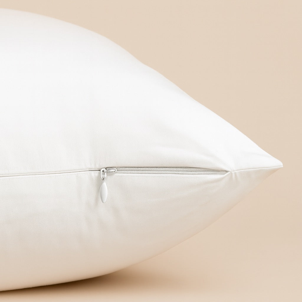 Close-up of a soft cream custom pillow cover featuring a hidden zipper for easy access