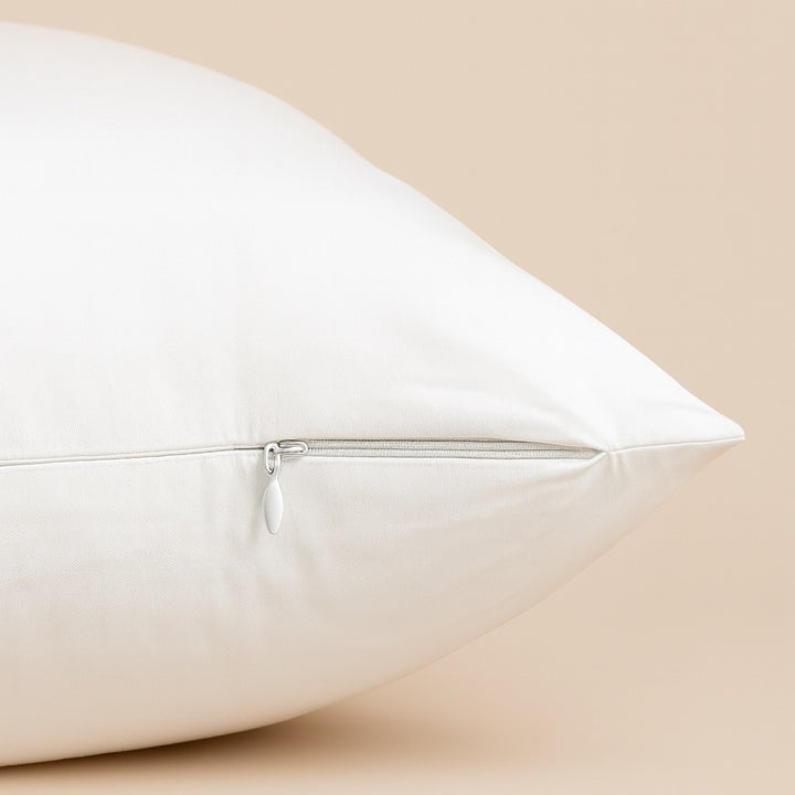Close-up of a soft cream custom pillow cover featuring a hidden zipper for easy access