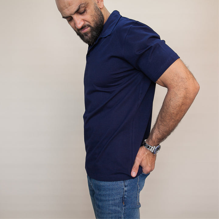 Dreamwithreem custom polo t-shirt in navy blue, featured on a model with a casual stance