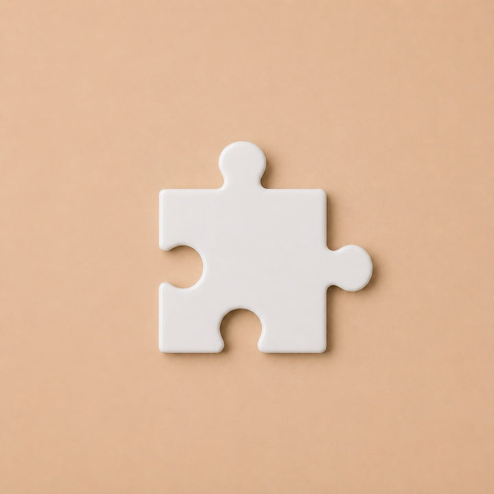 Single white puzzle piece for custom puzzles showing smooth edges and modern design