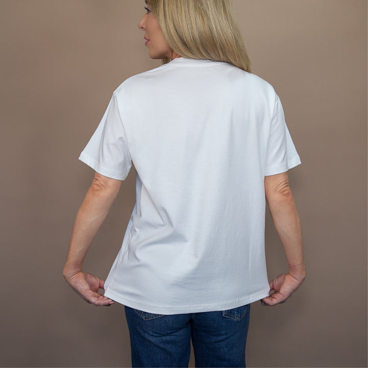Back view of a woman wearing a white custom relaxed fit t-shirt ideal for casual wear