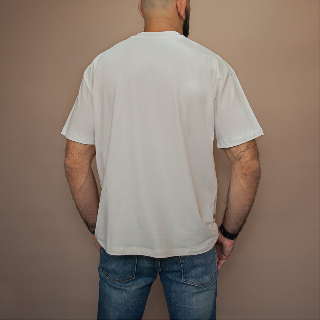 Back view of a man wearing a custom relaxed fit t-shirt in a neutral color
