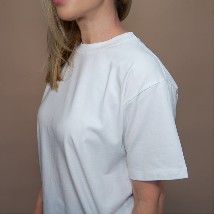 Model wearing a white custom relaxed fit t-shirt showcasing a casual style and comfortable fabric