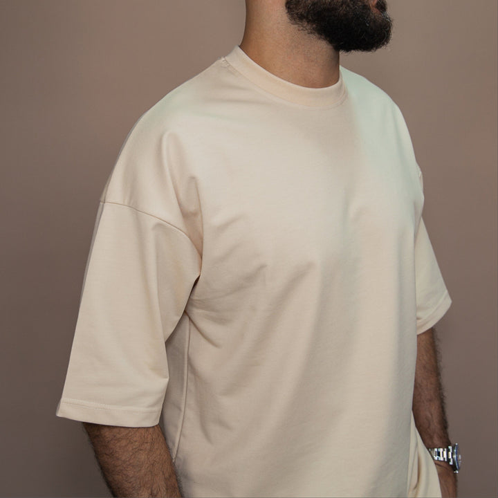 Custom two-piece set in beige featuring a relaxed fit short sleeve shirt for casual style