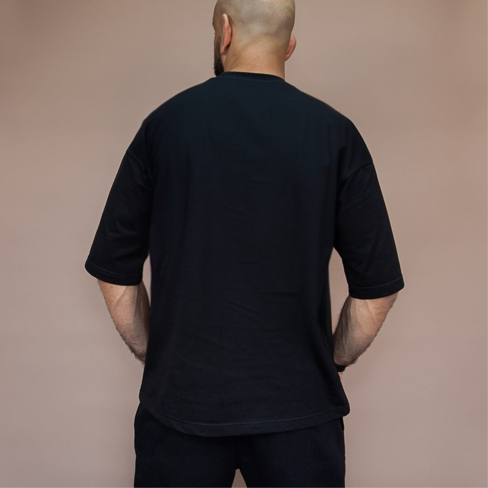 Back view of a man wearing a custom two-piece set in black for a stylish and comfortable look