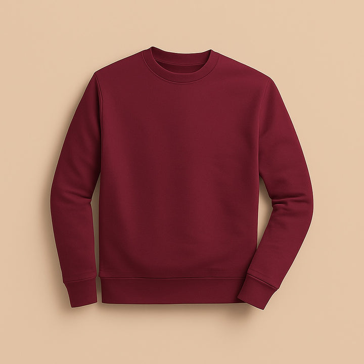 Burgundy crewneck jumper laid flat on beige background from dreamwithreem to design your own sweatshirt online