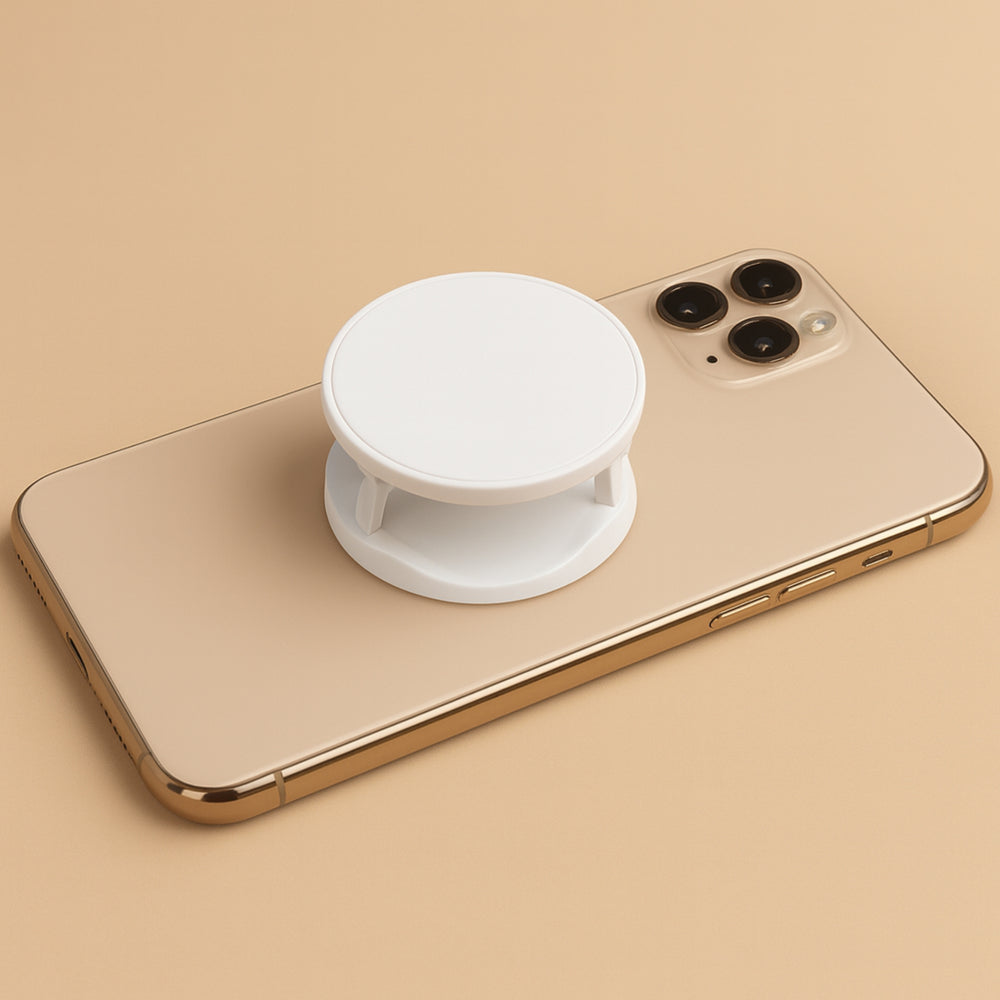 White customizable mobile phone accessory mounted on a gold smartphone for enhanced grip and usability