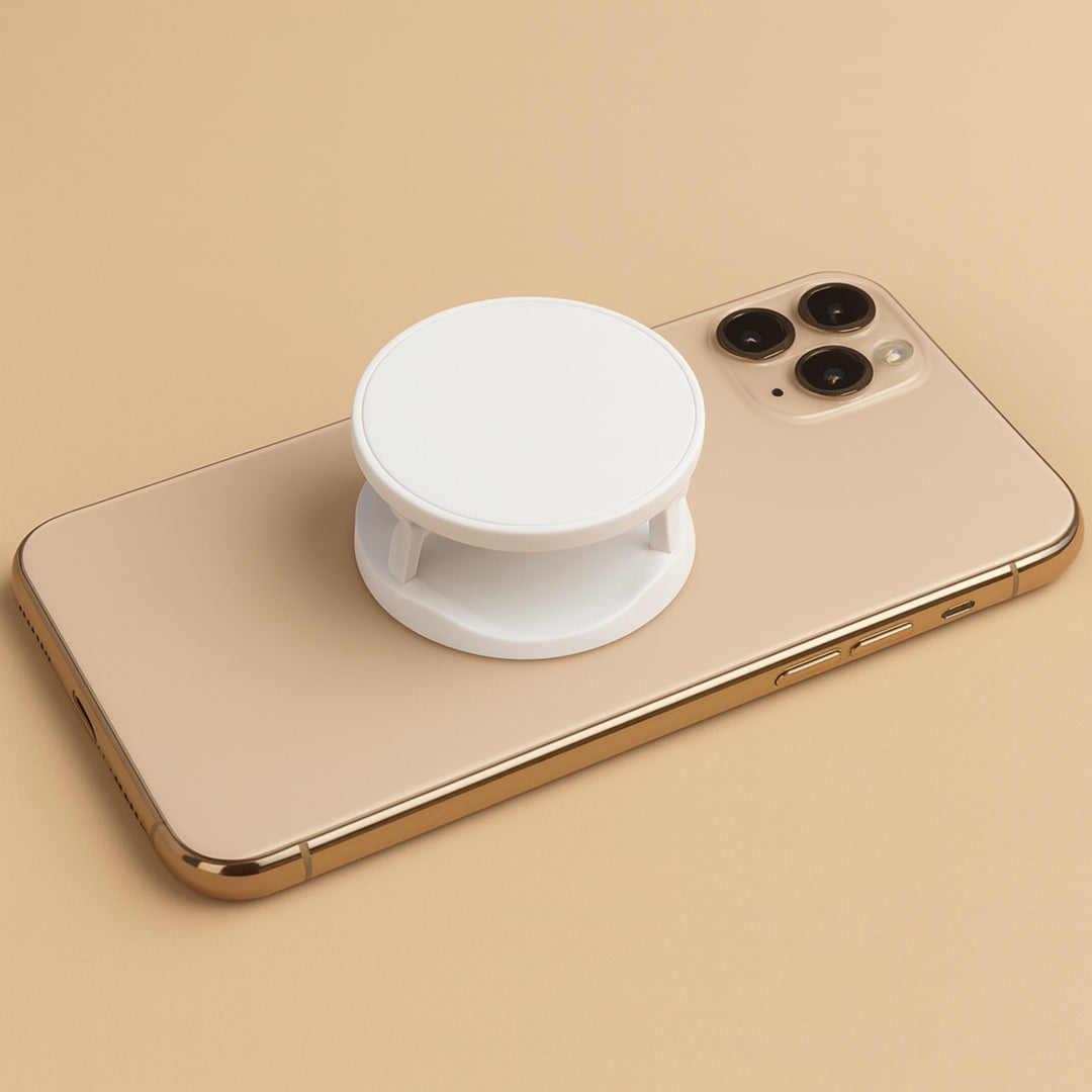White customizable mobile phone accessory mounted on a gold smartphone for enhanced grip and usability