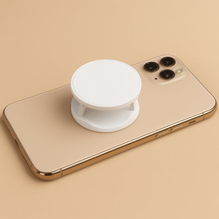 White customizable mobile phone accessory mounted on a gold smartphone for enhanced grip and usability