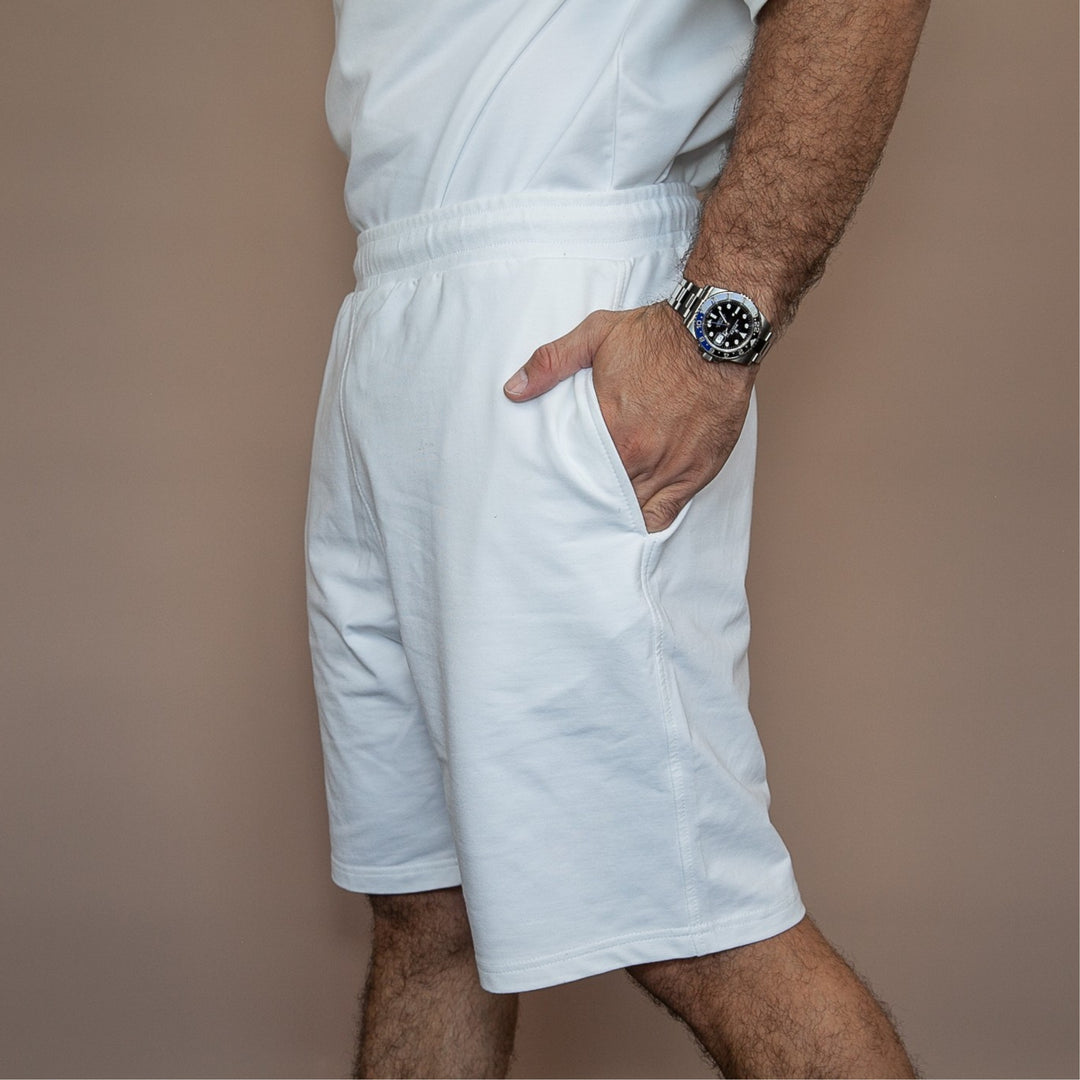 White customized casual shorts with elastic waistband and side pockets, perfect for relaxed outings