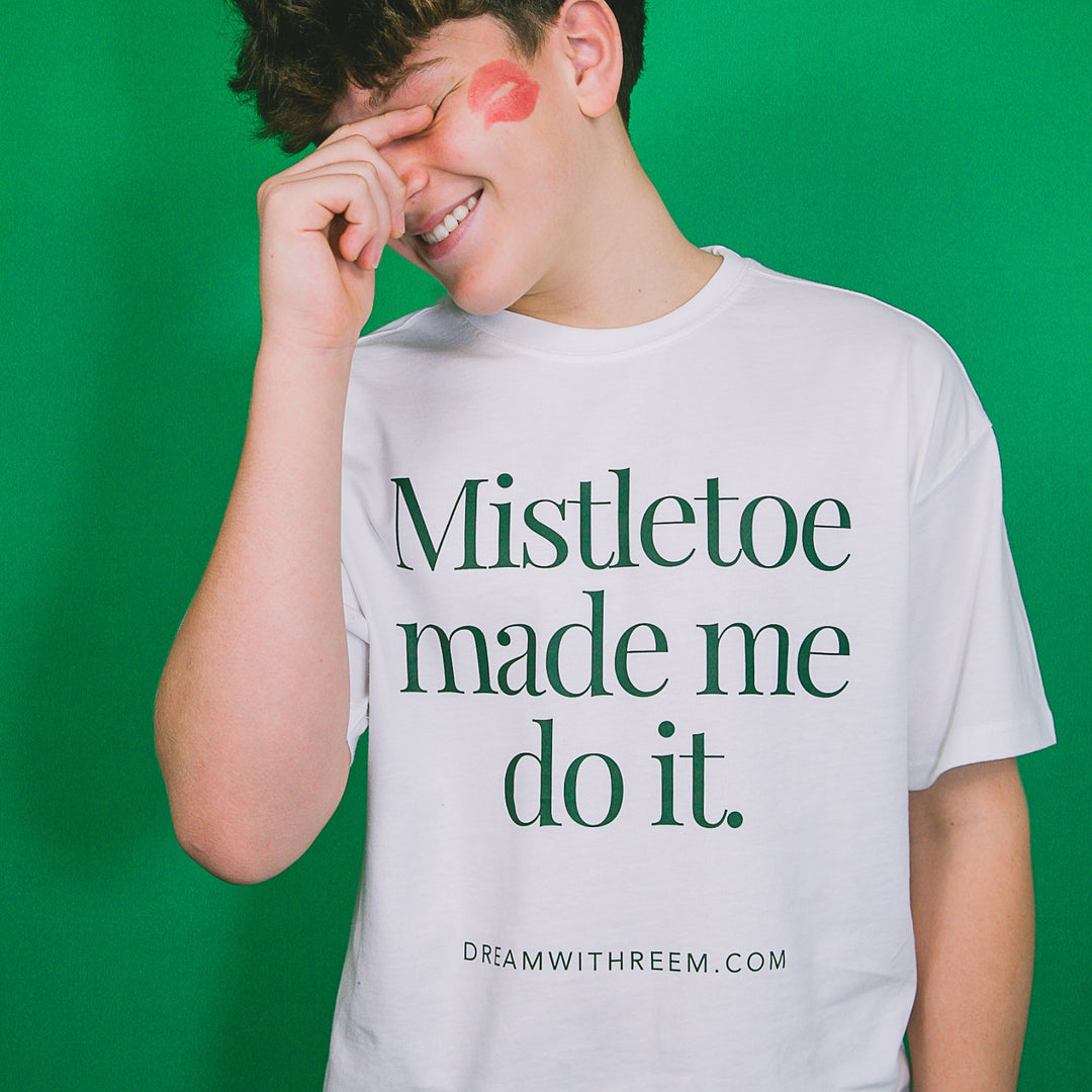 Custom holiday party graphic tee with mistletoe design and playful theme by dreamwithreem