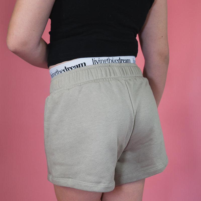Back view of comfortable camo shorts in light green worn with black top by dreamwithreem