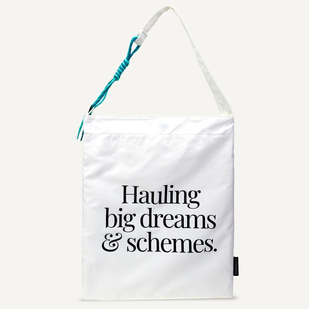 dreamwithreem white signature style carryall bag with black text hauling big dreams and schemes