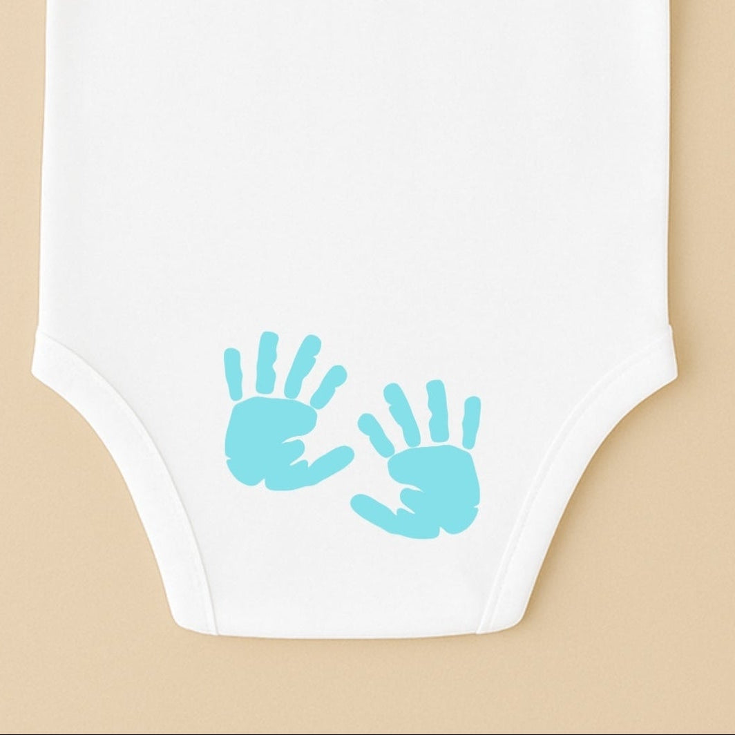 Personalized baby bodysuit featuring blue hand prints for a unique touch