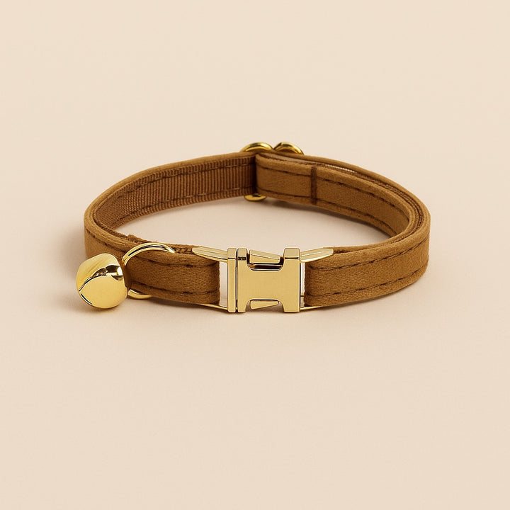 Personalized cat collar with name in brown fabric featuring a gold bell and adjustable buckle