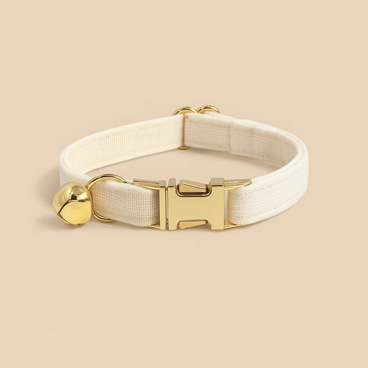 Stylish personalized cat collar with name in cream color featuring a gold bell and clasp