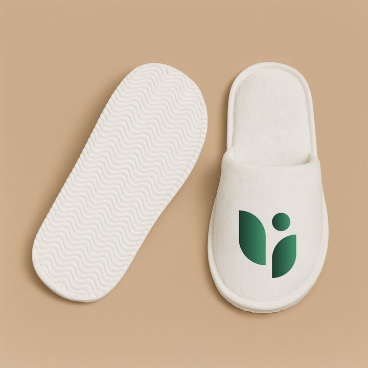 Dreamwithreem personalized hotel slippers featuring a soft white design with a green logo
