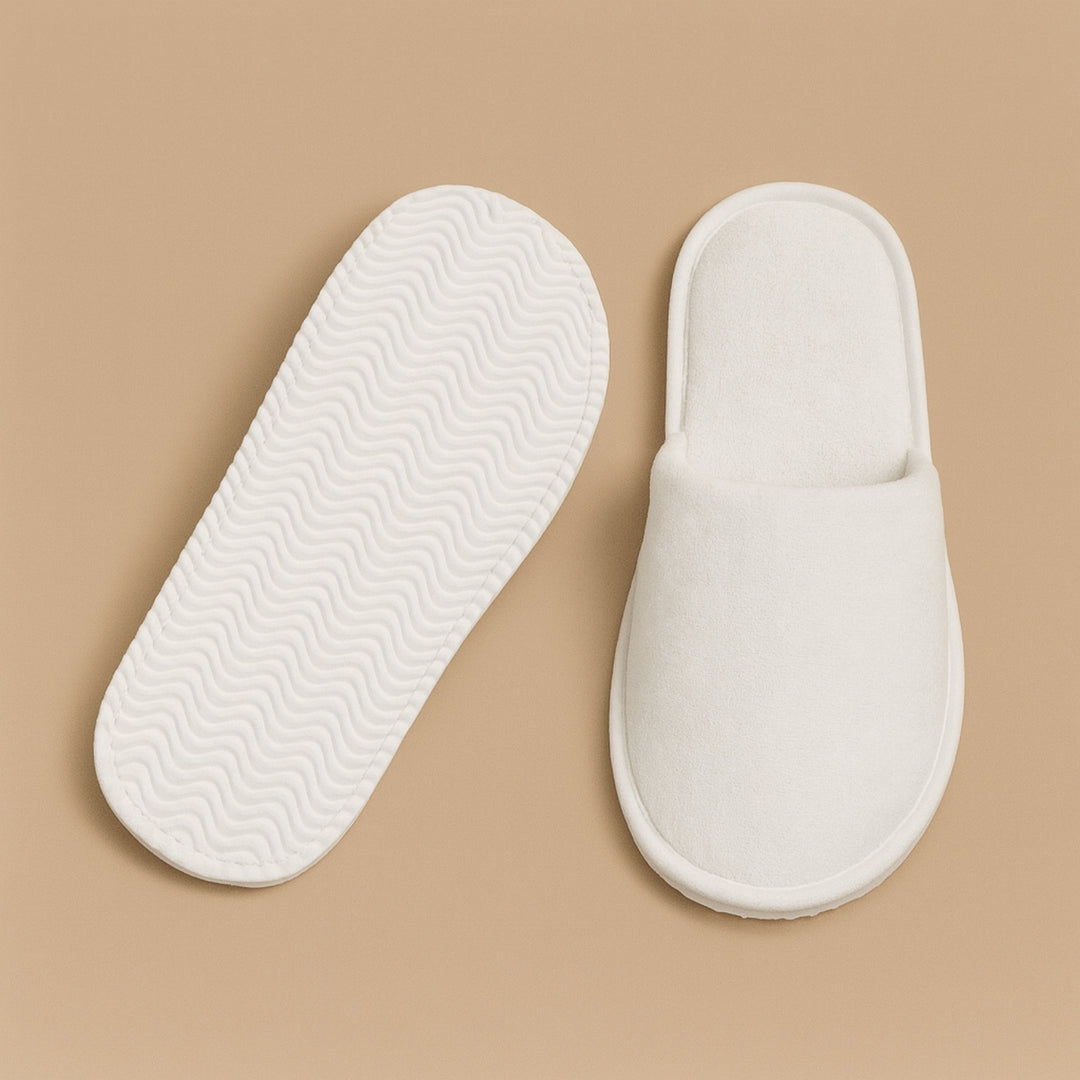 Soft white personalized hotel slippers for a comfortable and luxurious stay