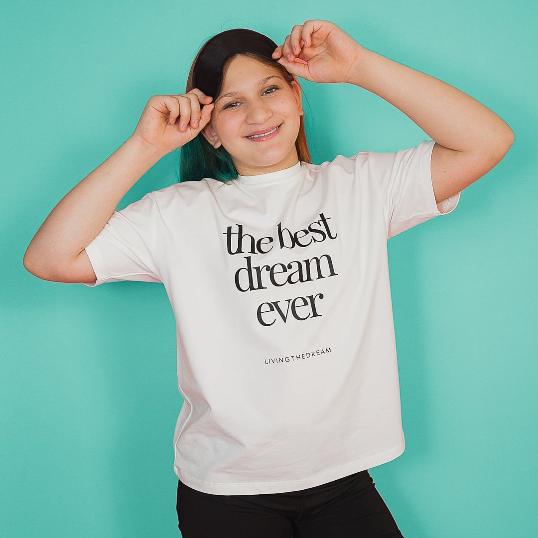 Smiling woman wearing a white custom T-shirt with the text the best dream ever personalized statement shirts