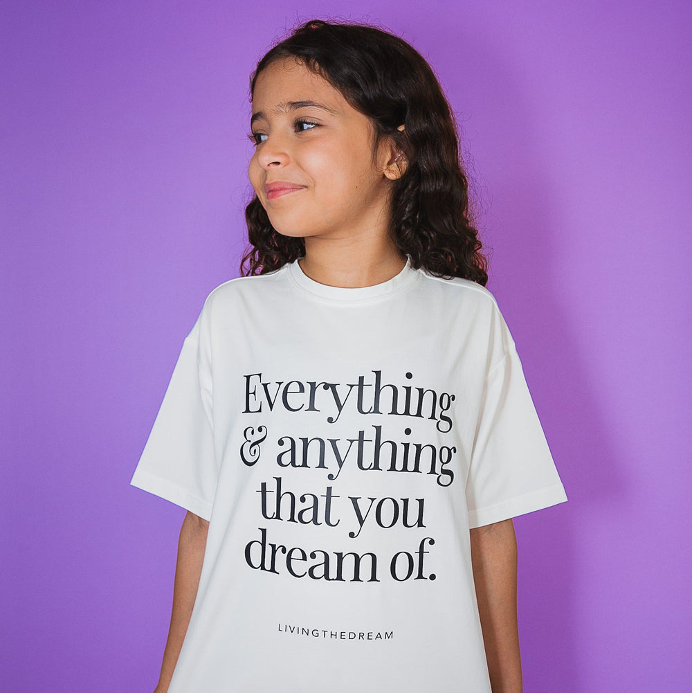 Young girl wearing a white custom Positive Statement Tees shirt with inspiring text on front